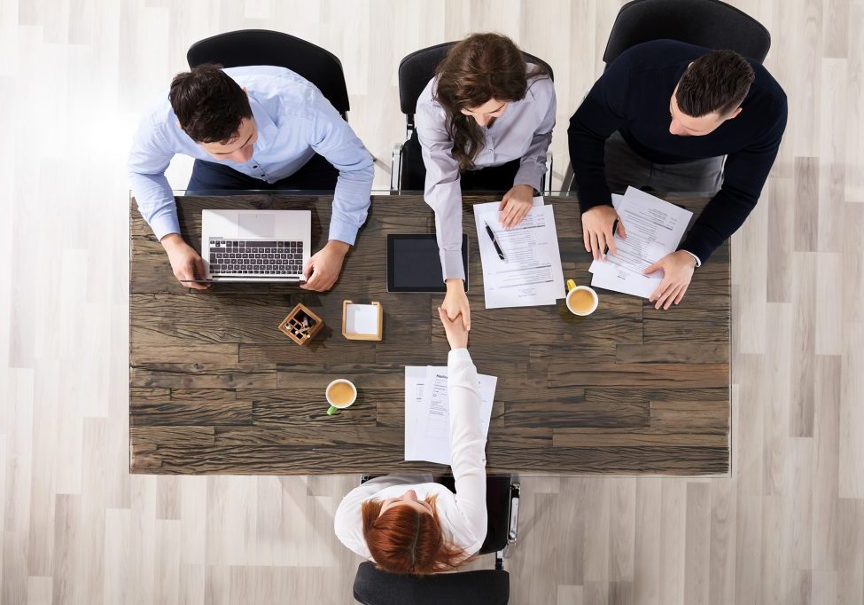 Group Of Corporate Recruitment Officers Shaking Hand With Candidate Arrived For Interview