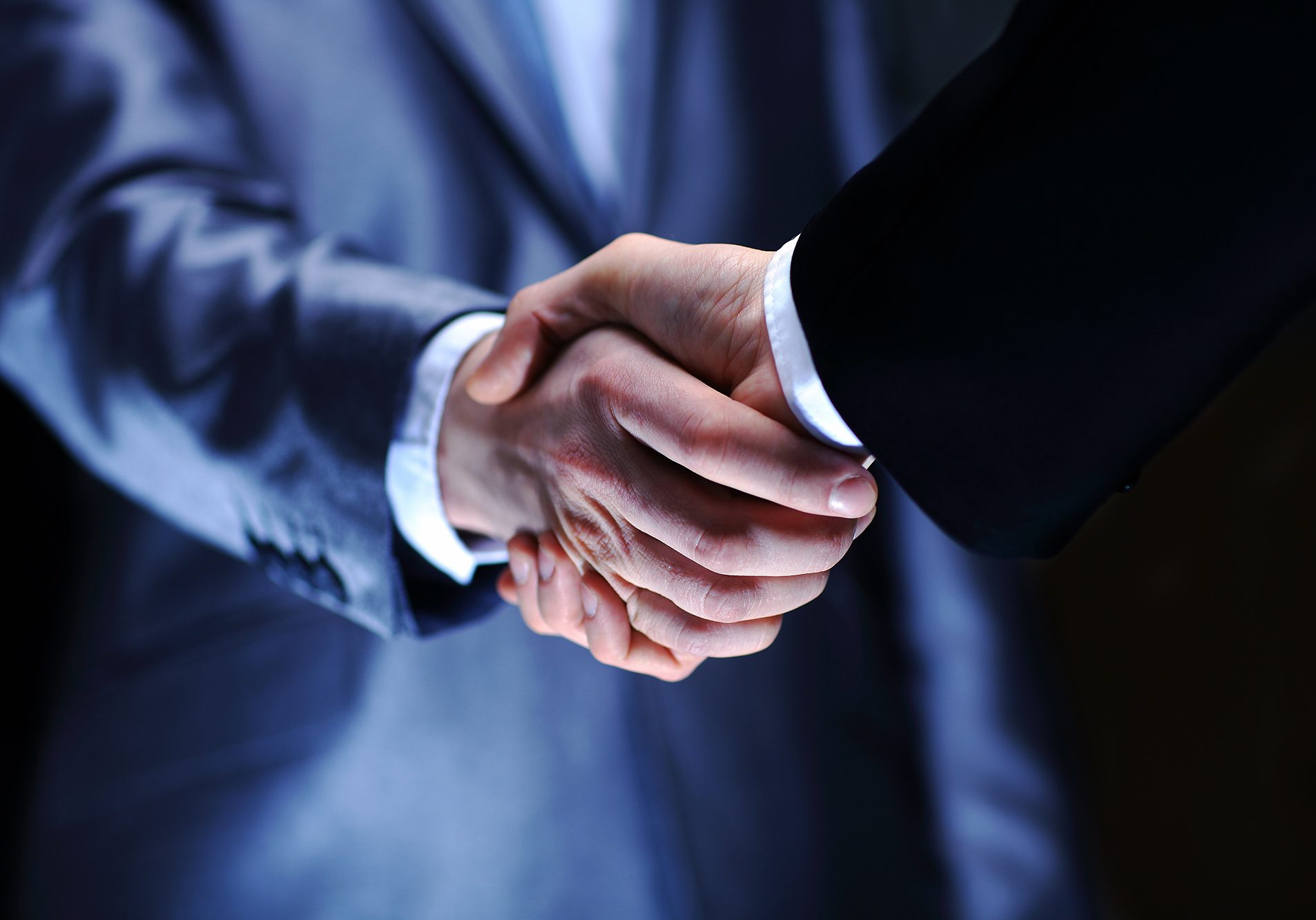 Handshake - Hand holding on black background